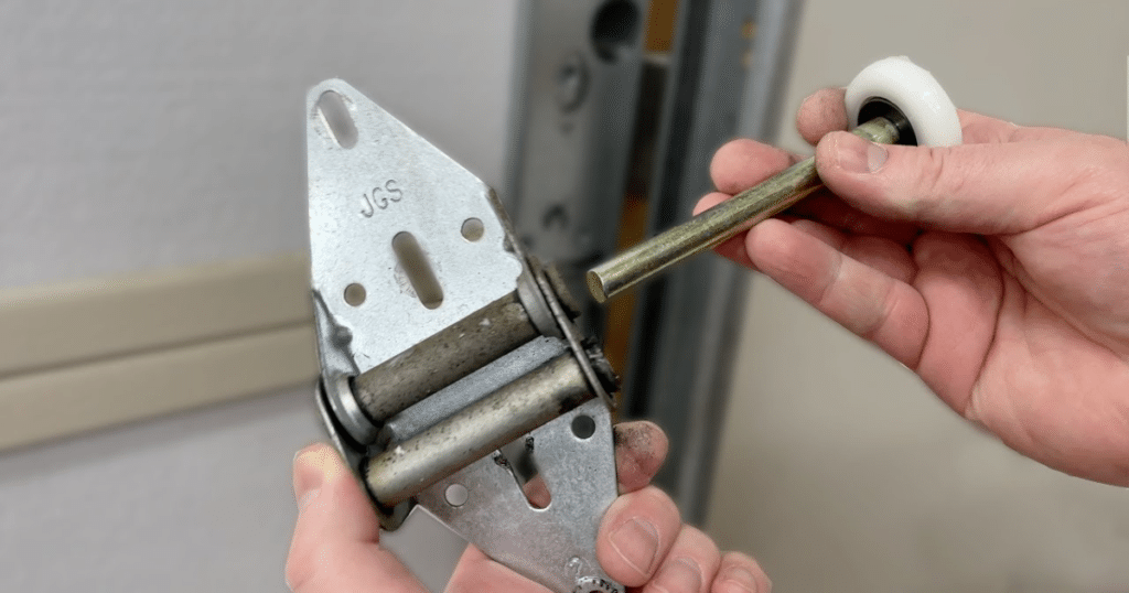 Garage door hinge and roller assembly.