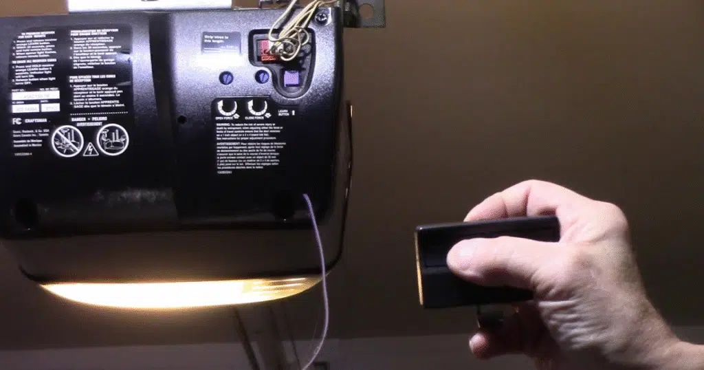 Man programs garage door remote device